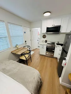 a kitchen with a bed and a table in a room at Cozy Villa with Spa, Fireplace, Kitchen, Yard, BBQ in Simi Valley