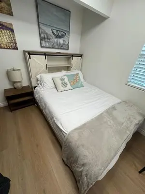a bedroom with a large bed with white sheets at Cozy Villa with Spa, Fireplace, Kitchen, Yard, BBQ in Simi Valley