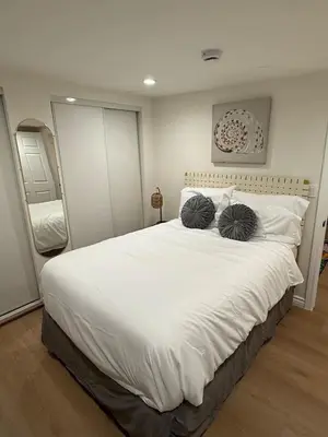 a bedroom with a large white bed with two pillows at 1BR 1BA Kitchenette, Arcade, Patio BBQ, Fire Pit in Simi Valley