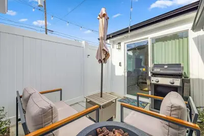 a patio with chairs and a grill and an umbrella at 1BR 1BA Kitchenette, Arcade, Patio BBQ, Fire Pit in Simi Valley