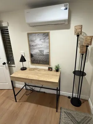 a table in a room with two lamps and a painting at 1BR 1BA Kitchenette, Arcade, Patio BBQ, Fire Pit in Simi Valley