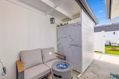 a living room with a couch and a table at 2BR 2BA Home Hot Tub, Firepit, Yard, BBQ, Parking in Simi Valley