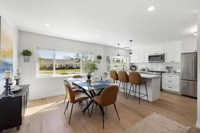 a kitchen and dining room with a table and chairs at 2BR 2BA Home Hot Tub, Firepit, Yard, BBQ, Parking in Simi Valley