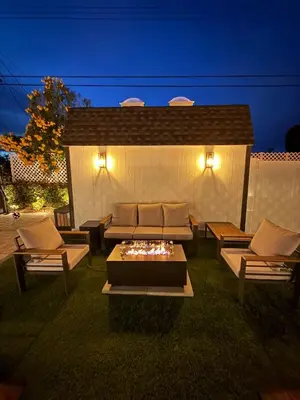 a patio with couches and a fire pit in the grass at 2BR 2BA Home Hot Tub, Firepit, Yard, BBQ, Parking in Simi Valley