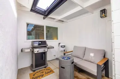 a living room with a couch and a stove at 2BR 2BA Home Hot Tub, Firepit, Yard, BBQ, Parking in Simi Valley