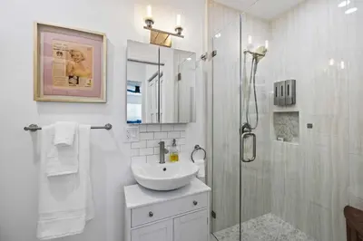 a white bathroom with a sink and a shower at 2BR 2BA Home Hot Tub, Firepit, Yard, BBQ, Parking in Simi Valley