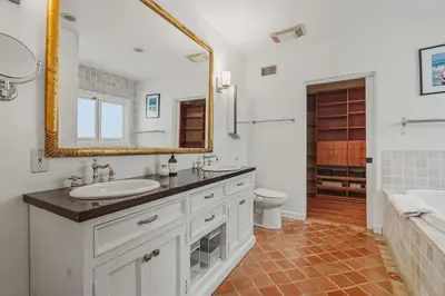 a bathroom with a sink and a mirror and a toilet at New Listing Elevated Hillside Living by Colby & Conrad in Los Angeles