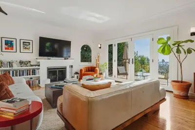 a living room with a couch and a fireplace at New Listing Elevated Hillside Living by Colby & Conrad in Los Angeles