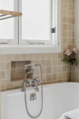 a bath tub with a shower head in a bathroom at New Listing Elevated Hillside Living by Colby & Conrad in Los Angeles