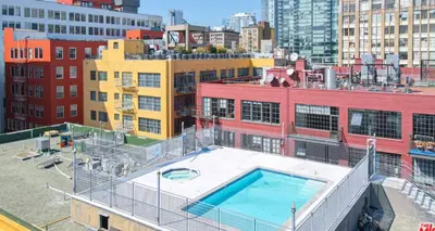 a building with a swimming pool on top of it at Chic urban loft steps from dining and shopping in Los Angeles