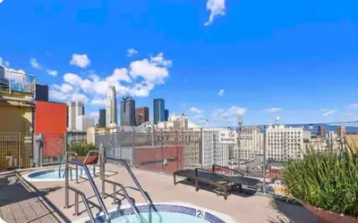 a balcony with a view of a city skyline at Chic urban loft steps from dining and shopping in Los Angeles