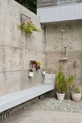a stone wall with a bench and potted plants at New Listing Modern Hollywood Hills Sanctuary by Colby & Conrad in Los Angeles