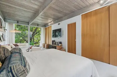 a bedroom with a bed and a living room at New Listing Modern Hollywood Hills Sanctuary by Colby & Conrad in Los Angeles
