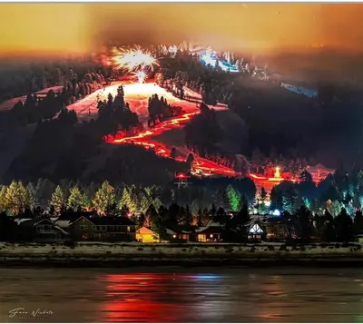 a ski resort with fireworks on a mountain at night at Luxury Lakefront Retreat,HotTub,EV Charge,Fire Pit in Big Bear Lake