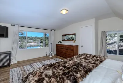 a bedroom with a large bed and a large window at Luxury Lakefront Retreat,HotTub,EV Charge,Fire Pit in Big Bear Lake
