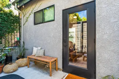 a door to a patio with a bench and a table at Modern Luxe Studio in East Los Angeles in Los Angeles