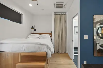 a bedroom with a bed and a tv on a wall at Modern Luxe Studio in East Los Angeles in Los Angeles