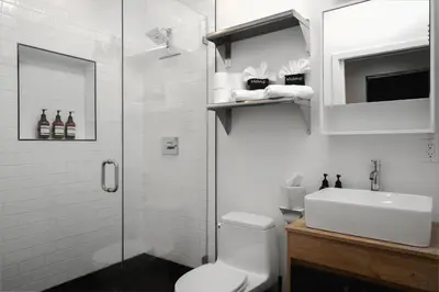a bathroom with a shower and a toilet and a sink at Modern Luxe Studio in East Los Angeles in Los Angeles