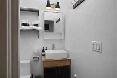 a bathroom with a sink and a mirror at Modern Luxe Studio in East Los Angeles in Los Angeles