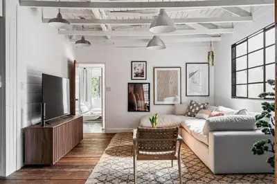 a living room with a couch and a tv at Elegant 3-bedroom home Retreat in East Los Angeles in Los Angeles