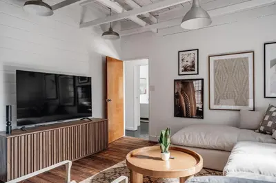 a living room with a couch and a tv at Elegant 3-bedroom home Retreat in East Los Angeles in Los Angeles