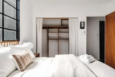 a bedroom with a large white bed with white pillows at Elegant 3-bedroom home Retreat in East Los Angeles in Los Angeles