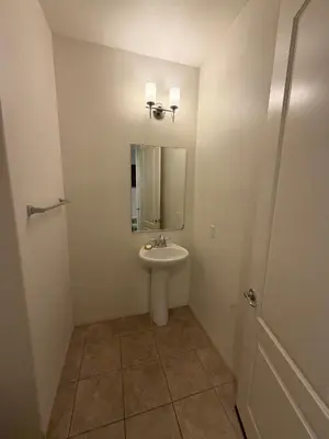 a bathroom with a sink and a mirror at Cozy 2-Bedroom Home in Eastvale in Corona