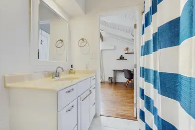 a bathroom with a sink and a mirror at Mountain Playhouse in Lake Arrowhead
