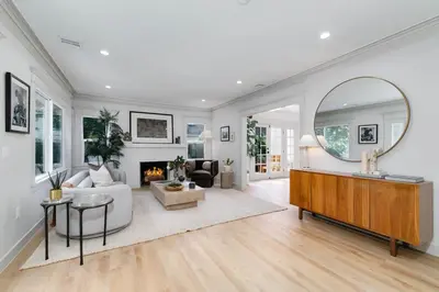 a living room with a large mirror and a fireplace at Chic WeHo Retreat near Sunset Blvd in Los Angeles