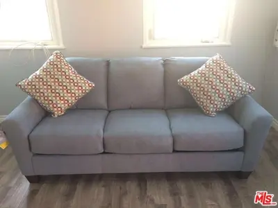 a blue couch with two pillows on it in a living room at Cozy Studio Apt Studio City Unit 5 in Los Angeles