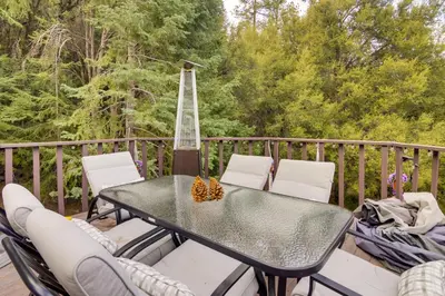 a table and chairs on a deck with a guitar at Outdoor Oasis in Pine Mountain Club! Cabin Getaway in Pine Mountain Club