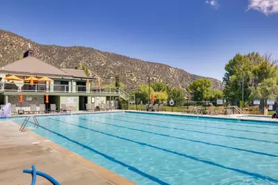 a large swimming pool with a mountain in the background at Outdoor Oasis in Pine Mountain Club! Cabin Getaway in Pine Mountain Club
