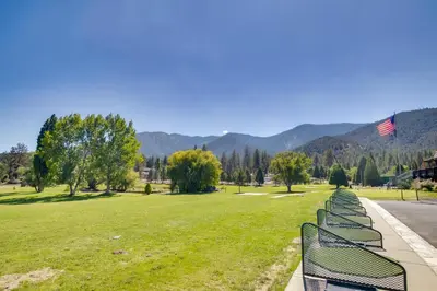 a row of benches in a park with mountains in the background at Outdoor Oasis in Pine Mountain Club! Cabin Getaway in Pine Mountain Club