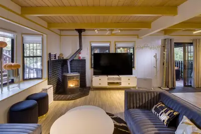 a living room with a couch and a tv at Outdoor Oasis in Pine Mountain Club! Cabin Getaway in Pine Mountain Club