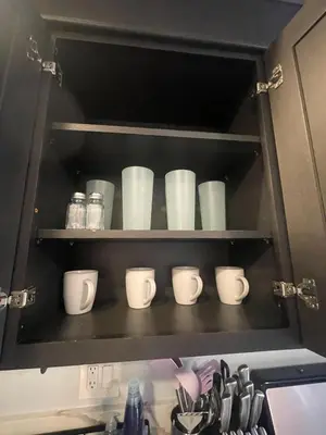 a cupboard with a bunch of white cups in it at Cozy 1 Bedroom Tarantino Unit Studio City in Los Angeles