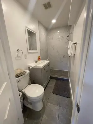 a bathroom with a toilet and a sink and a shower at Cozy 1 Bedroom Tarantino Unit Studio City in Los Angeles