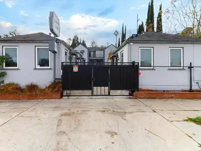 a black gate in front of a house at Cozy 1 Bedroom Tarantino Unit Studio City in Los Angeles