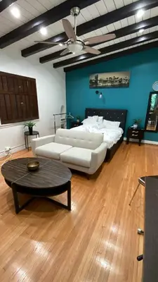 a living room with a couch and a bed and a table at Cozy Studio by Rodeo Drive in Los Angeles