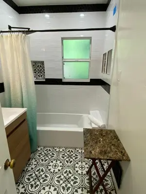 a bathroom with a tub and a window and a sink at Cozy Studio by Rodeo Drive in Los Angeles