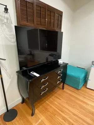 a room with a desk with a flat screen tv at Cozy Studio by Rodeo Drive in Los Angeles