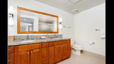 a bathroom with a sink and a toilet and a mirror at Admiralty 2BD Luxe Retreat with FREE PARKING in Los Angeles