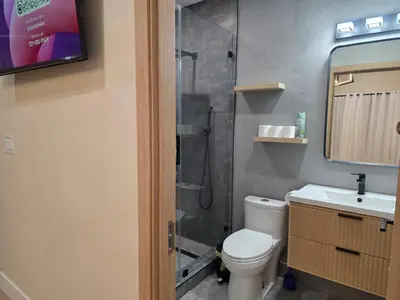 a bathroom with a shower and a toilet and a sink at Private Studio City Suite Walk to Universal-15 min in Los Angeles