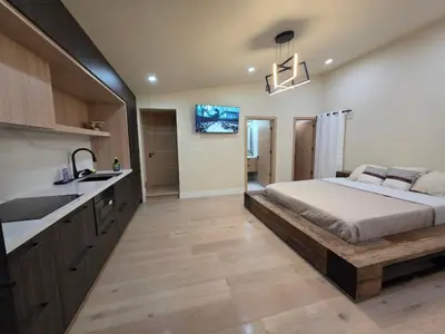 a bedroom with a bed and a sink and a kitchen at Private Studio City Suite Walk to Universal-15 min in Los Angeles