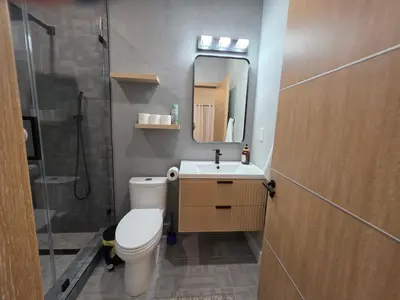 a bathroom with a toilet and a sink and a shower at Private Studio City Suite Walk to Universal-15 min in Los Angeles
