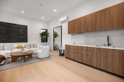 a kitchen and living room with a couch and a table at Colfax Estate in Los Angeles