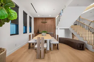 a dining room with a table and some stairs at Colfax Estate in Los Angeles