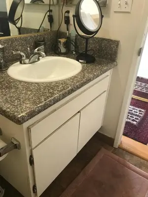 a bathroom counter with a sink and a mirror at Fara UCLA in Los Angeles
