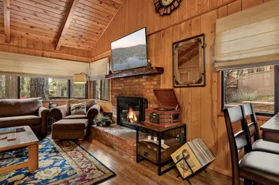 a living room with a fireplace in a house at Pinecone Den in Big Bear Lake