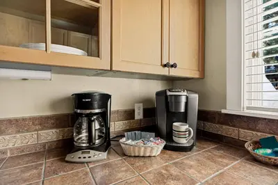 a kitchen counter with a coffeemaker and a coffee maker at Snuggle Down Cottage in Big Bear Lake