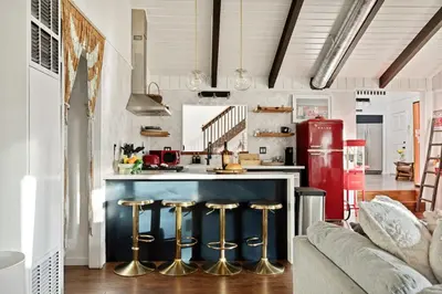a kitchen with a red refrigerator and bar stools at The Willow Cabin in Big Bear Lake